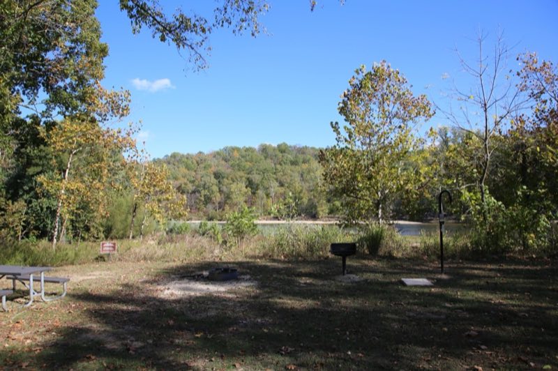 A campsite positioned just above the river's edge.