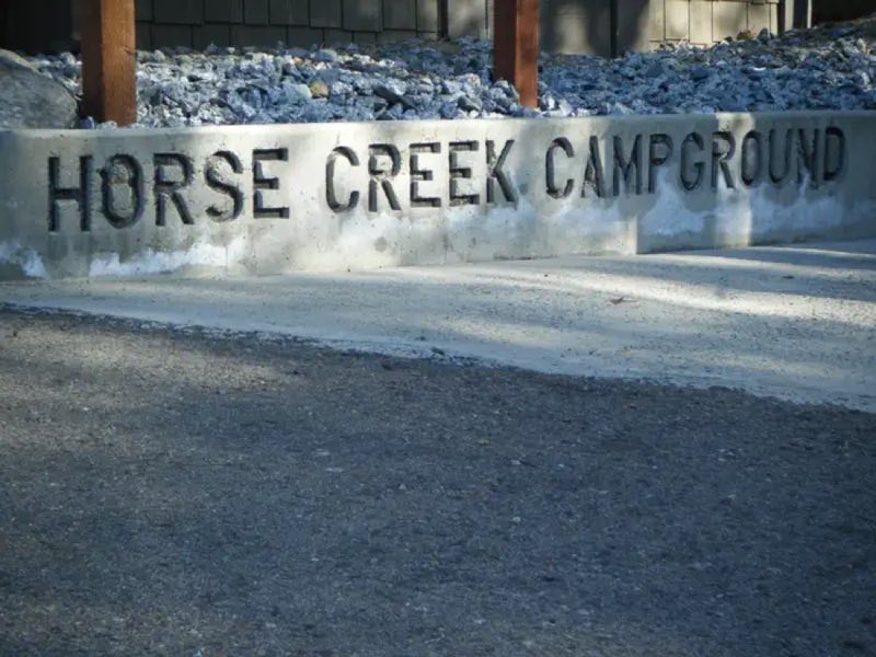 Campground sign in front of Fee Building/Registration.