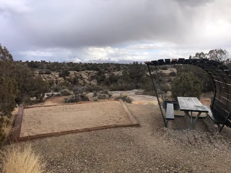 Tent campsites have picnic tables with shade structures, along with a tent pad.