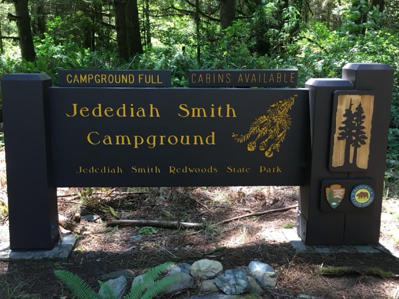 A brown and yellow campground sign.