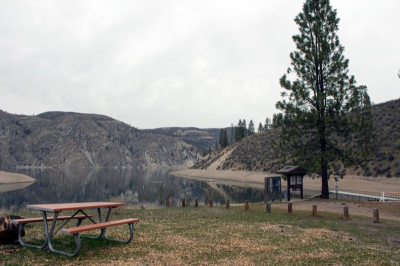 A view through a waterfront campsite to the boat launch.