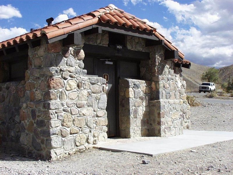 a stone building with red roof tiles